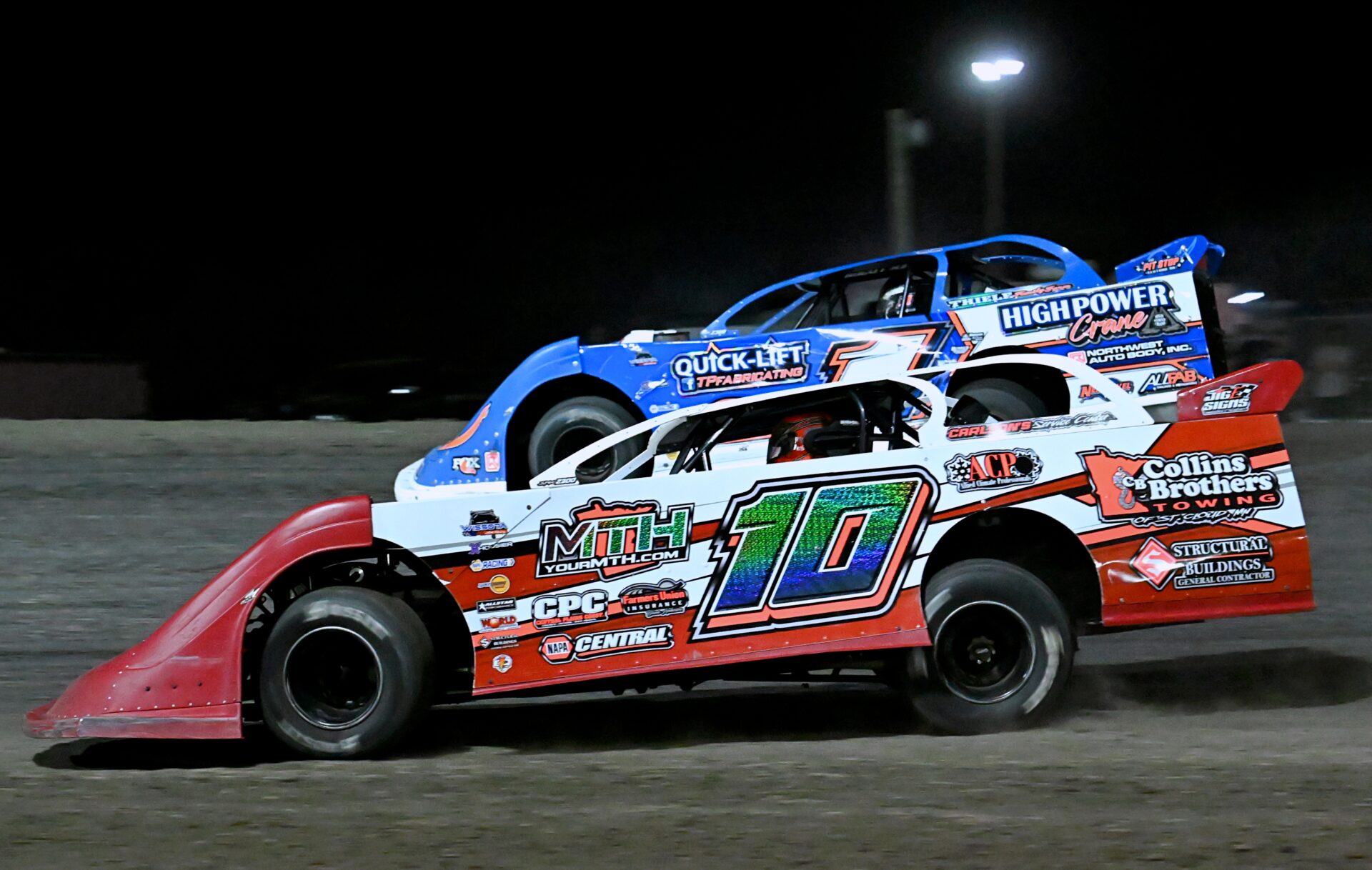 Huron's Cole Searing rides the bottom of the track and passes Tyler Peterson of Hickson, N.D., heading into turn four in the Late Model feature race during the Big Buck Nationals Saturday, Sept. 5 at Brown County Speedway. Searing took the checkered flag and won $3000. Aberdeen Insider photo by Robb Garofalo.