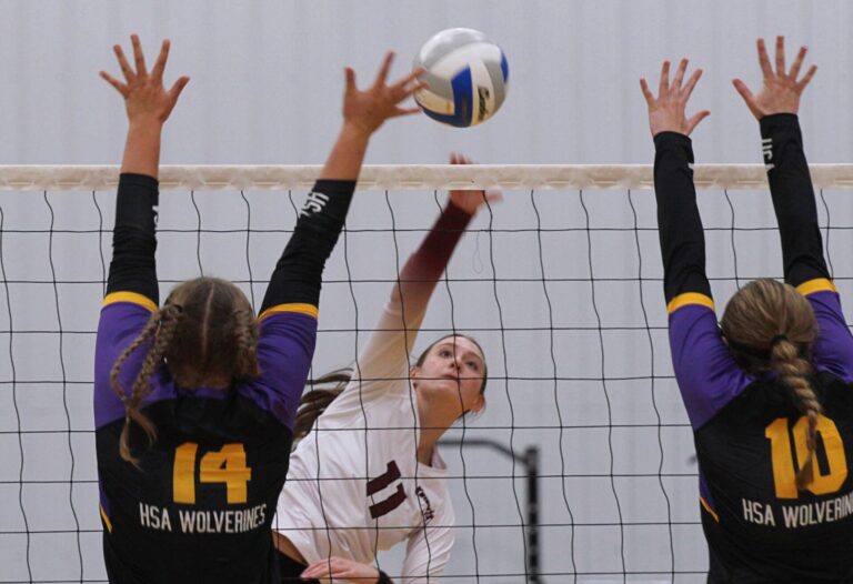 Aberdeen Christian's Arianna Johnson hits through the block attempt by Herreid/Selby Area's Rylee Hanson (14) and McKenna Beck during their match Thursday, Sept. 3 inside the Christian Gym. The Knights won in three sets. Aberdeen Insider photo by Allie Hoekman.