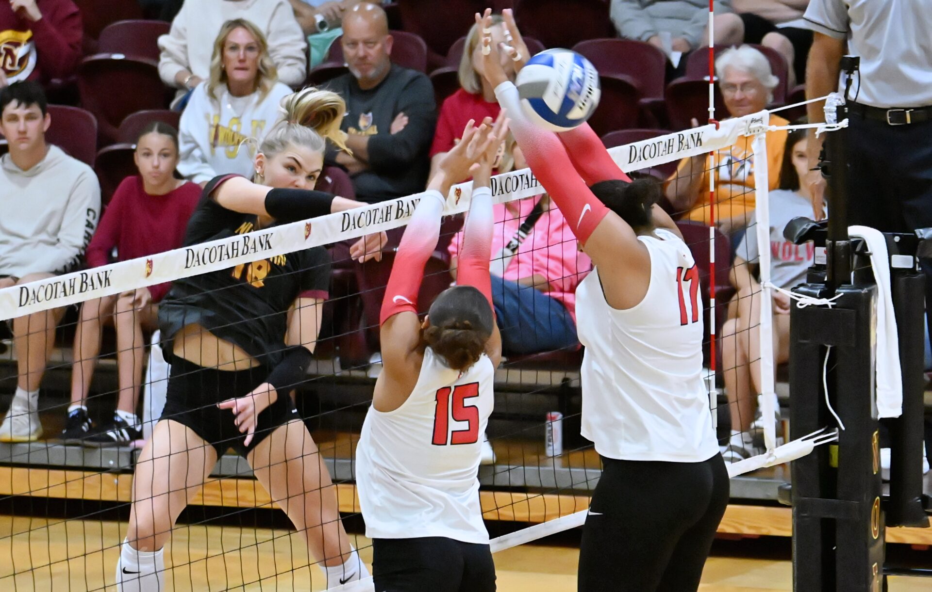 Northern State's Linnea Neisham rips a kill through the block attempt of Minnesota State Moorhead's Mya Pfeifer (15) and Raiah Mandell during the second set of the Wolves sweep on Saturday, Sept. 12 at Wachs Arena. Aberdeen Insider photo by Robb Garofalo.