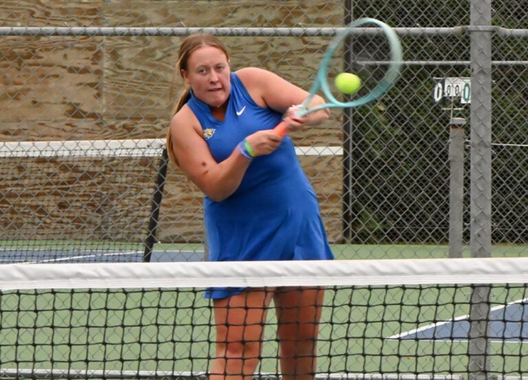 Aberdeen Central's Estelle Riggs leans into a backhand return during her singles match against Aberdeen Roncalli's Sydney Bohle Saturday, Sept. 19 at Holgate Middle School. Central won the dual 8-1. Aberdeen Insider photo by Robb Garofalo.