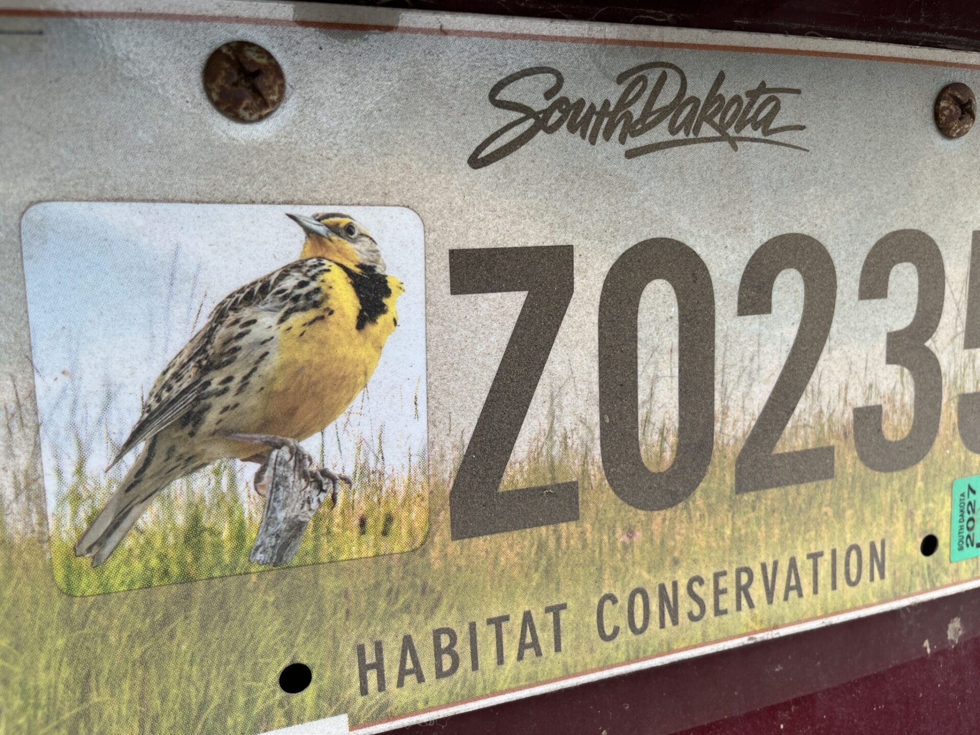Thousands of South Dakota habitat license plates do nothing for habitat, due to two-part process 1 A meadowlark habitat decal is affixed to a South Dakota habitat conservation license plate. The optional decal purchase is what helps to fund habitat conservation, and some people don't take the extra step. South Dakota Searchlight photo by Makenzie Huber.