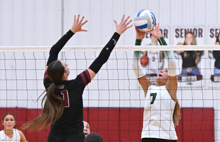 Aberdeen Roncalli's Jillian Ellwein tries to tip the ball over Aberdeen Christian's Arianna Johnson during a non-conference volleyball match Monday, Sept. 21 at the Christian Gym. The Cavaliers picked up a four-set victory. Aberdeen Insider photo by Robb Garofalo.
