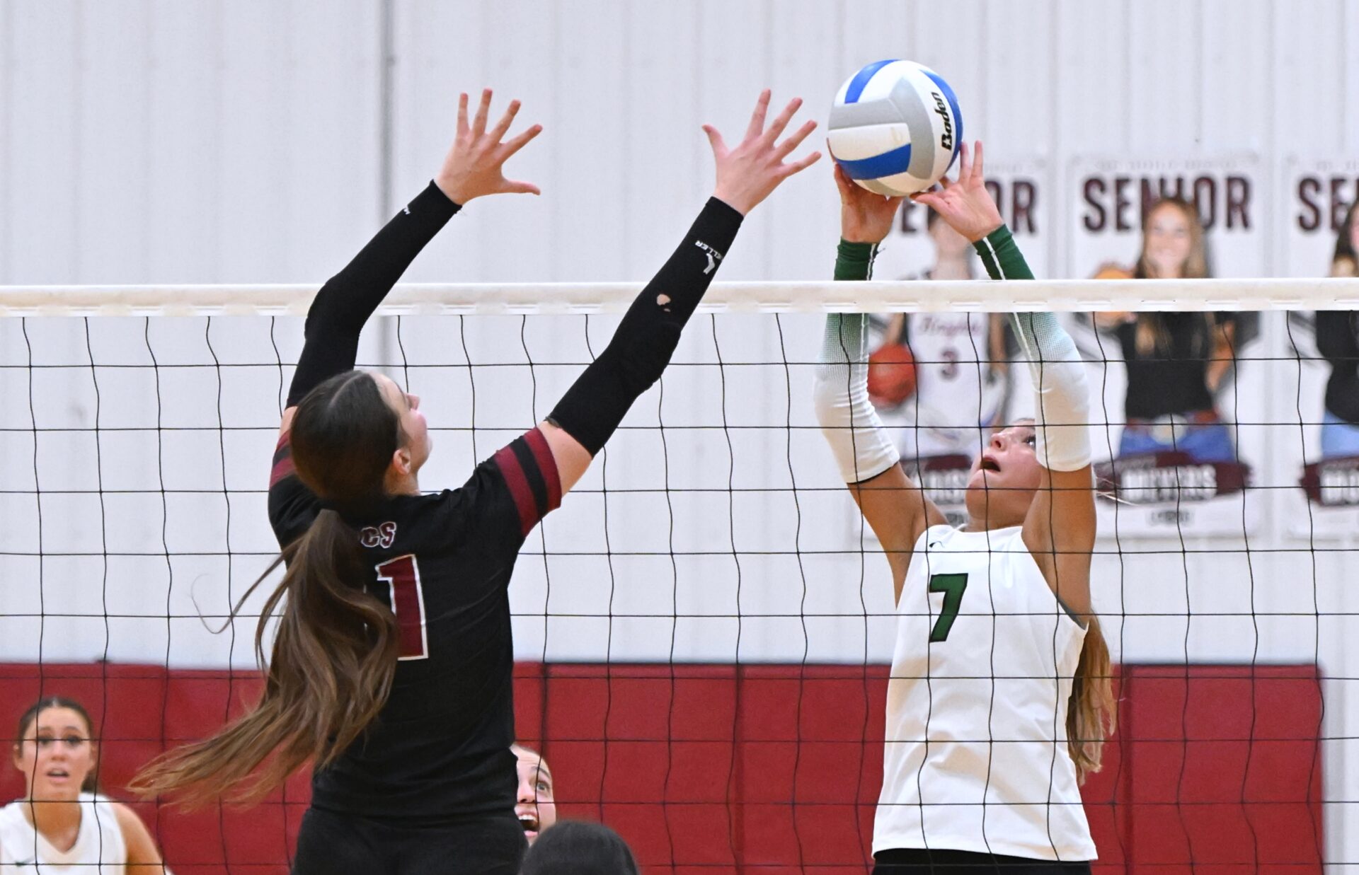 Aberdeen Roncalli's Jillian Ellwein tries to tip the ball over Aberdeen Christian's Arianna Johnson during a non-conference volleyball match Monday, Sept. 21 at the Christian Gym. The Cavaliers picked up a four-set victory. Aberdeen Insider photo by Robb Garofalo.