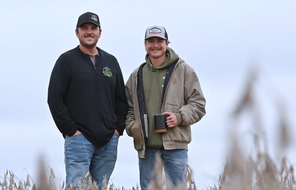 Wyatt Ewing, left, and Riley Reetz stand on the future site of the clubhouse at Sunken Prairie Golf Club on the Reetz farm south of Webster. The high-end golf course is scheduled to open in spring 2028. Aberdeen Insider photo by Robb Garofalo.