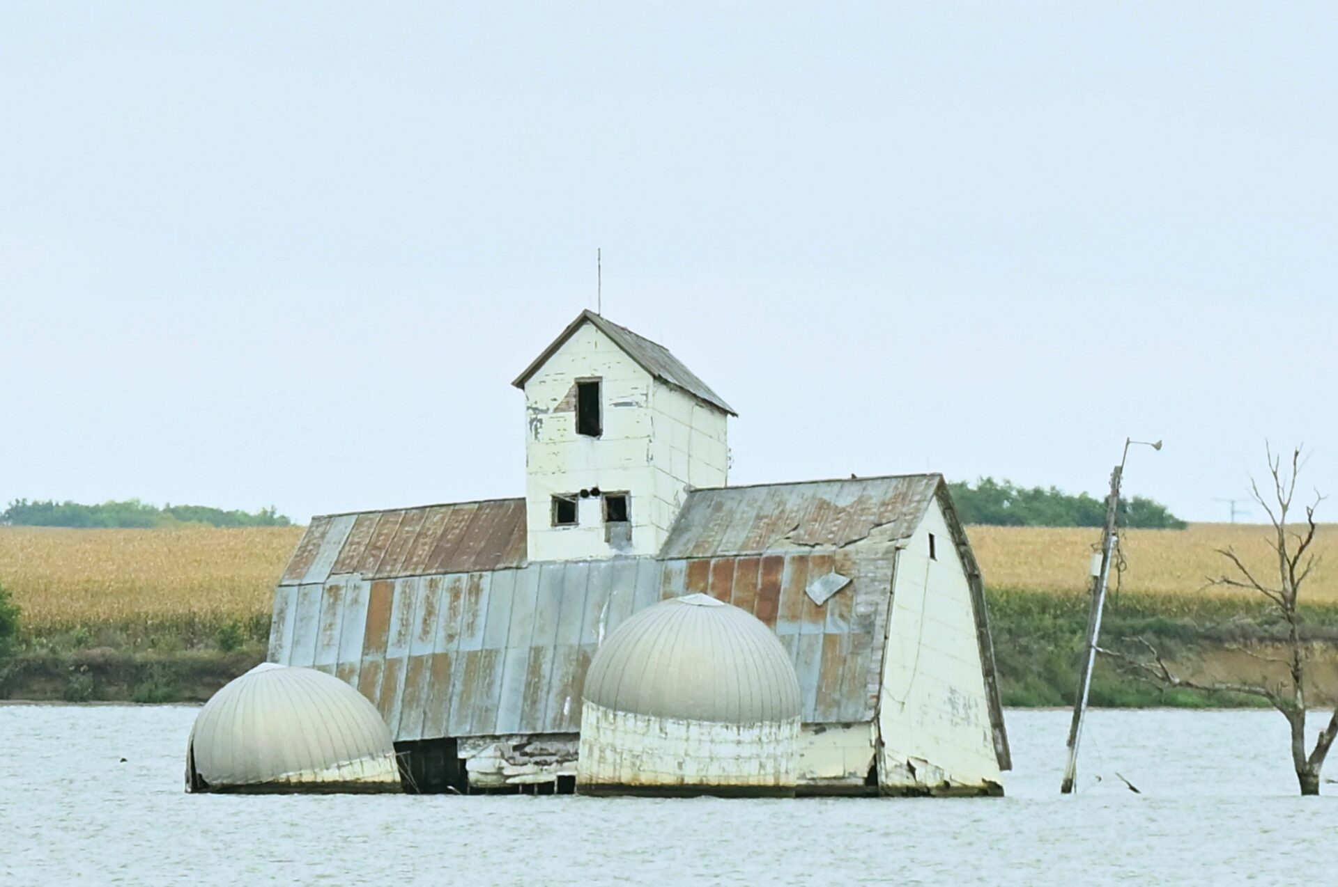 The barn and silos of the Reetz family farm sit in the middle of Reetz Lake. The buildings have become the centerpiece of Sunken Prairie Golf Club, scheduled to open in spring 2028 just south of Webster. Aberdeen Insider photo by Robb Garofalo.
