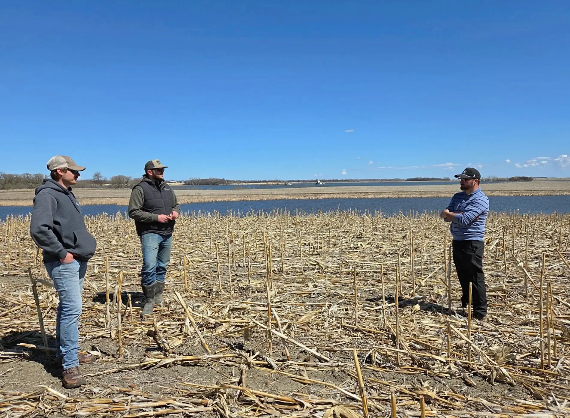 Riley Reetz, left, Wyatt Ewing and Colton Craig of Smyers, Craig and Coyne International Golf Course Architecture Group discuss the course layout of Sunken Prairie Golf Club, which is set to open in spring 2028 just south of Webster. Courtesy photo.