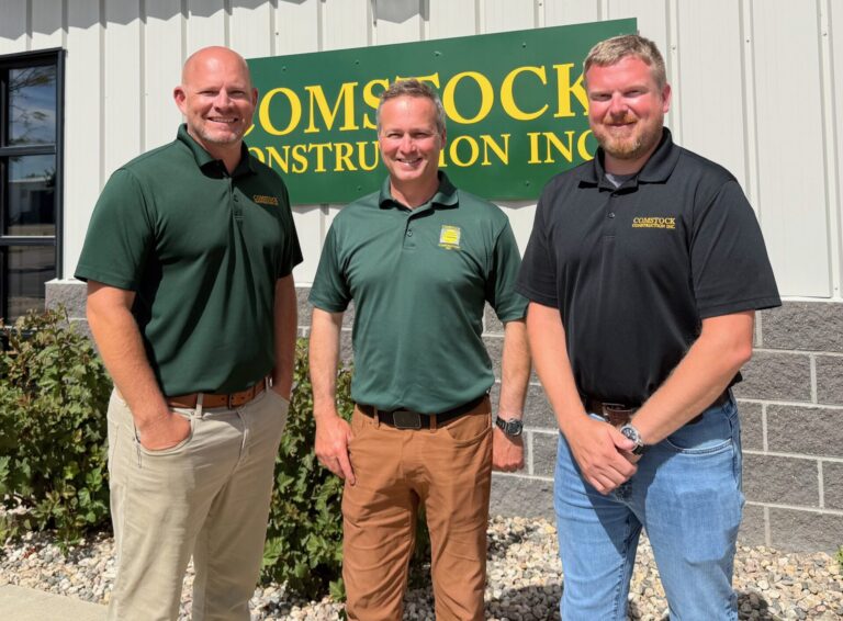Corey Sauerwein, left, business development representative at the Comstock Construction Aberdeen office, stands with Company CEO Michael Comstock and service project manager Jon Buchele. Aberdeen Insider photo by Elisa Sand.