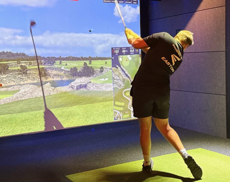 Brian Baker takes a swing during a round of golf at The Birdie Bay, a business with three golf simulators now open in Aberdeen. Aberdeen Insider photo by Elisa Sand.