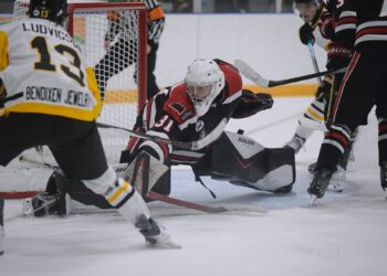 Aberdeen Wings goaltender Willum Braun slides across the crease for a save against Austin forward Brett Ludvigsen Saturday, Oct. 3 at the Odde Ice Center. Braun had 27 saves. Photo by Megan Rosendahl for the Aberdeen Insider.