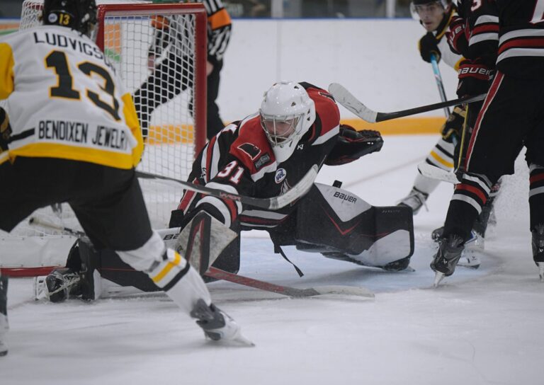 Aberdeen Wings goaltender Willum Braun slides across the crease for a save against Austin forward Brett Ludvigsen Saturday, Oct. 3 at the Odde Ice Center. Braun had 27 saves. Photo by Megan Rosendahl for the Aberdeen Insider.