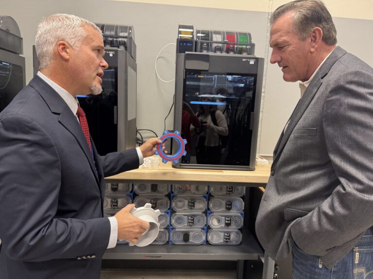 ATEC Academy director Robbie Johnson shows Gov. Larry Rhoden a new three-dimensional printer after a ribbon-cutting ceremony on Monday, Oct. 5 at ATEC. Aberdeen Insider photo by Shannon Marvel.