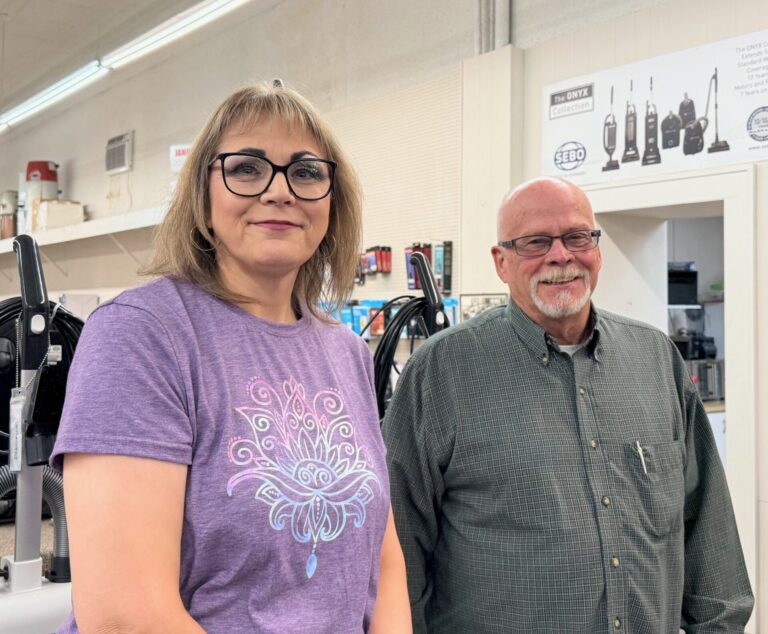 Shirelle Stadel, manager of The Fabric Bin and Sander's Sew-N-Vac, stands with owner Greg Sander. The businesses in downtown Aberdeen announced plans to close by mid-December. Aberdeen Insider photo by Elisa Sand.