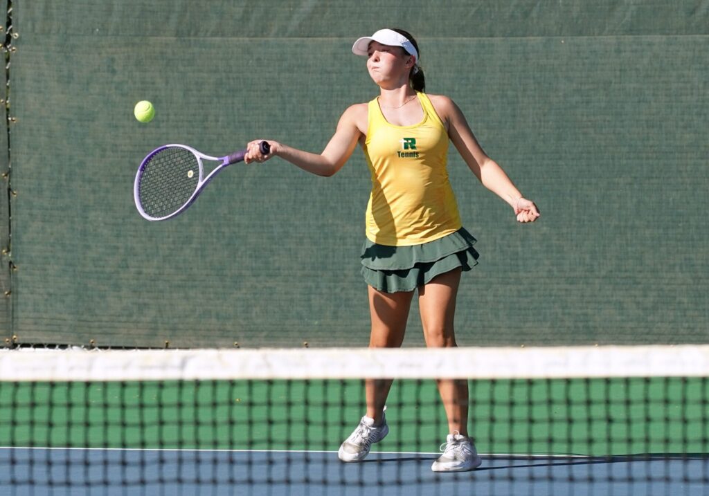 Aberdeen Roncalli's Abigail Andersen hits a forehand during the Class A state girls tennis tournament Tuesday, Oct. 6 in Rapid City. Andersen took second at fifth-flight singles, helping the Cavaliers tie for fourth place. Photo courtesy of South Dakota Public Broadcasting.